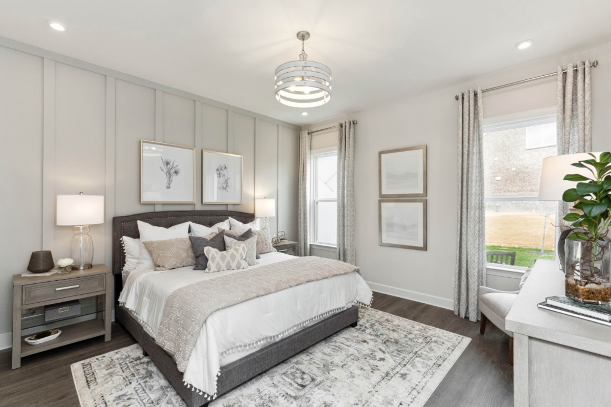 main-level primary bedroom with hardwood flooring