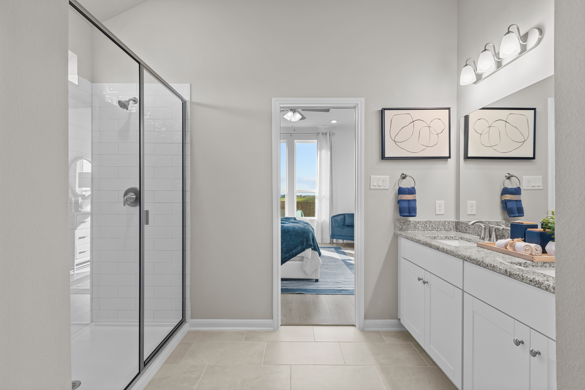 bathroom with walk-in shower & white cabinets 