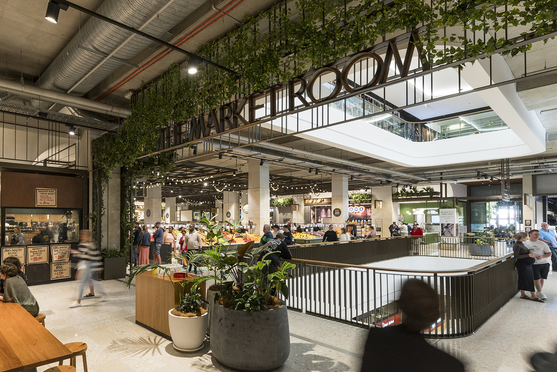 Image of a market room in a shopping centre with customers enjoying food and waling around