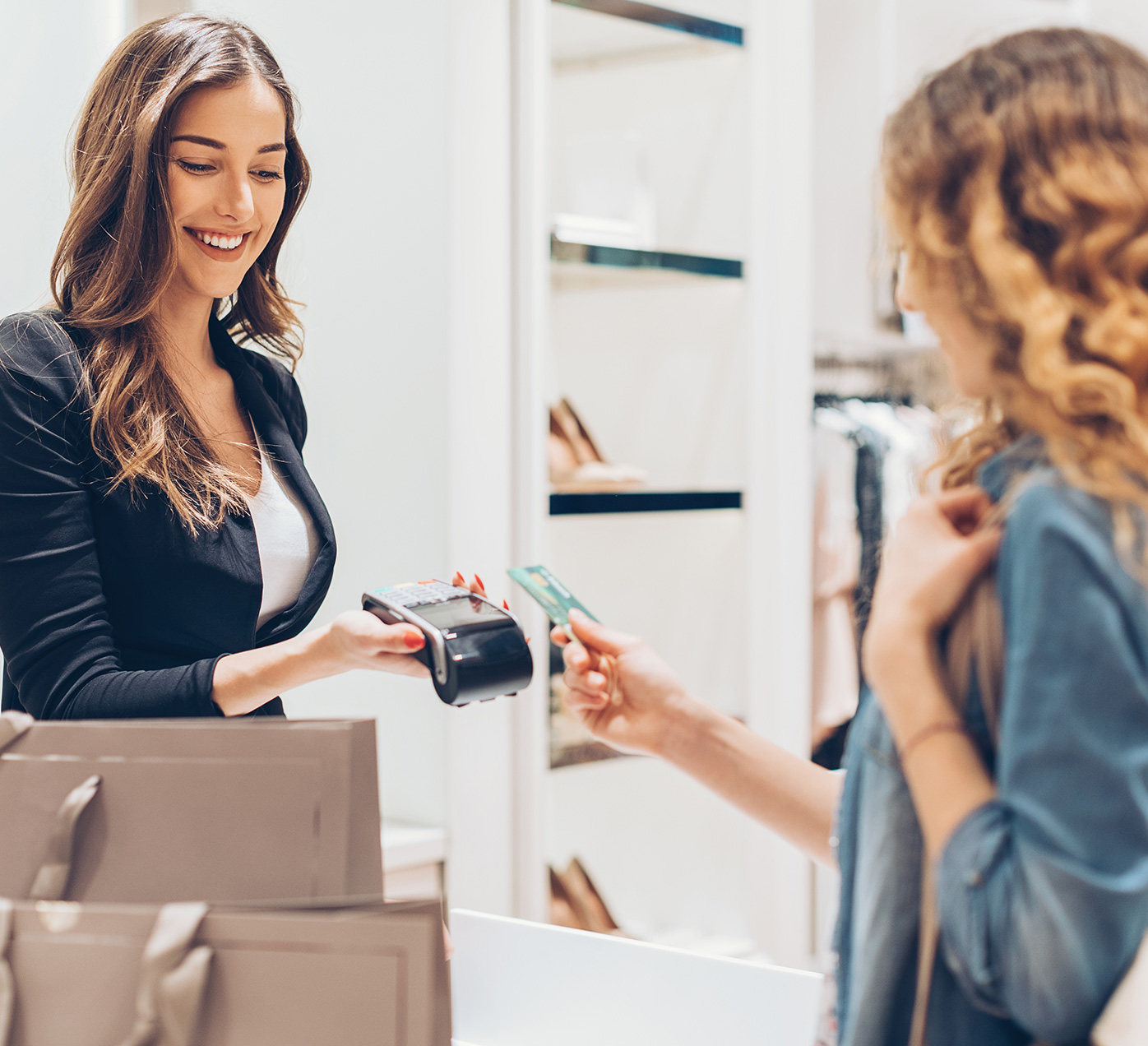 Woman paying with credit card at the checkout counter.