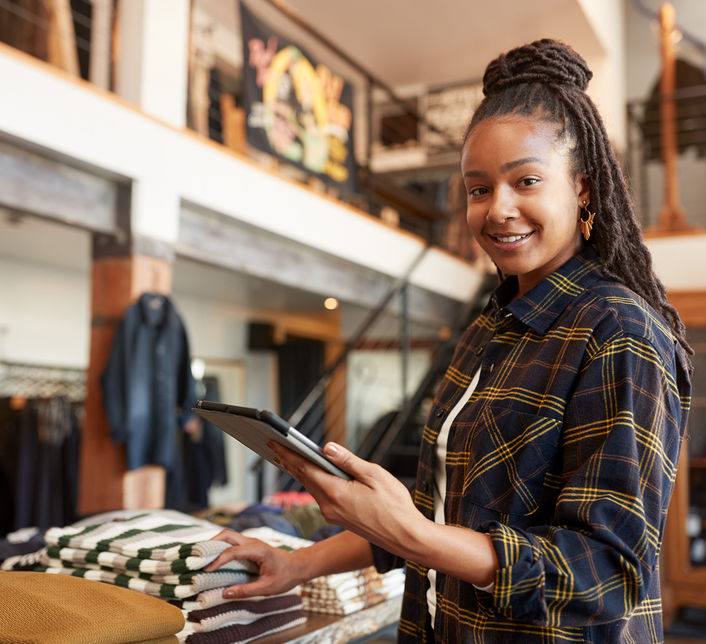 Associate in clothing store holding iPad
