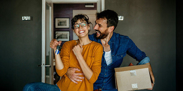 Happy couple moving into a home