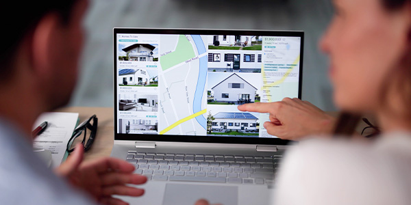 A couple looking at home listings online.
