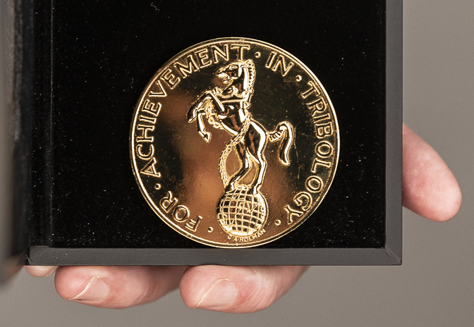 close up of tribology gold medal