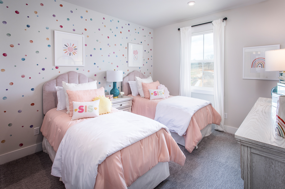 secondary bedroom with neutral carpet & twin beds