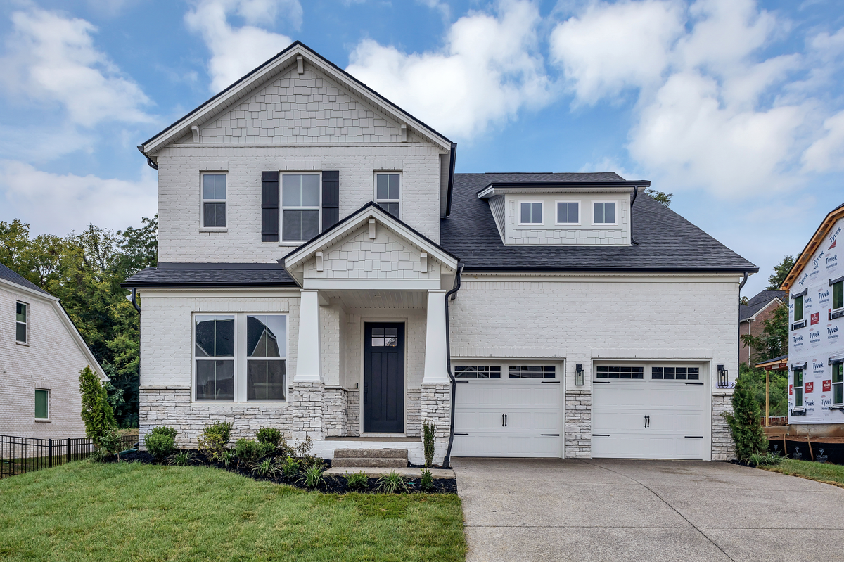 white brick home exterior with double-bay garage