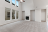 great room with carpet flooring, fireplace, and two story windows