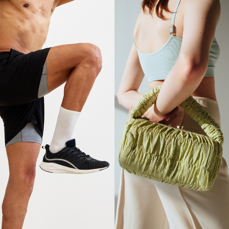 man wearing black running shoe, woman wearing light blue crop, beige pants and light green bag