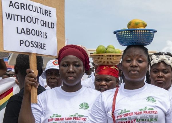 A group of activists marching with a sign that reads 