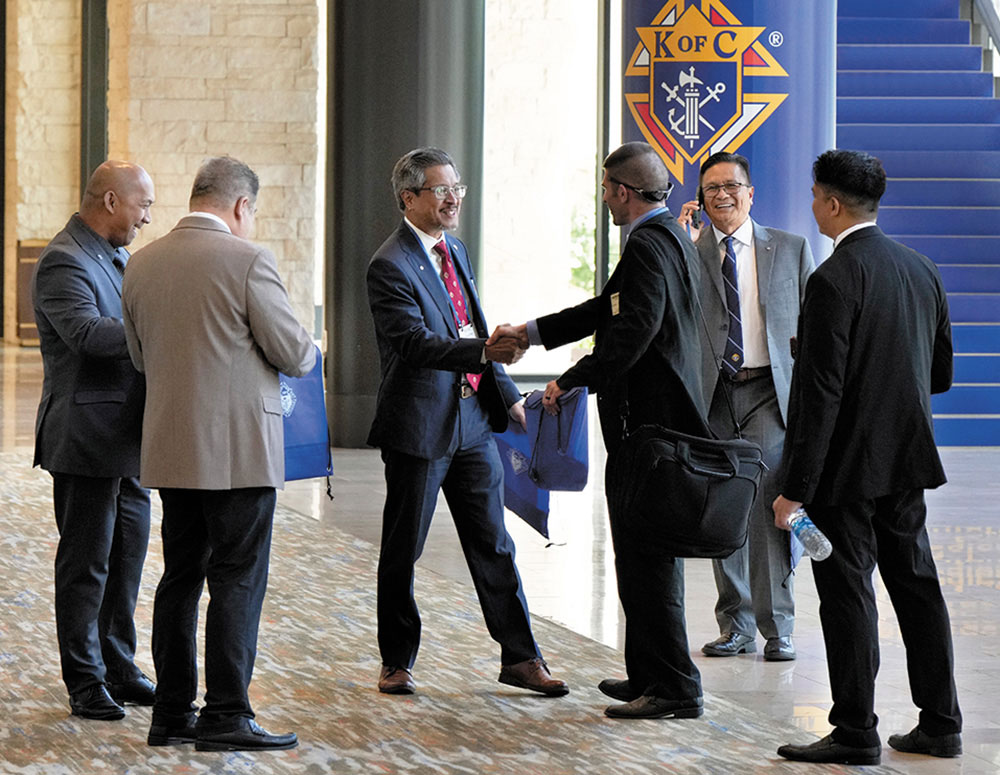 Field Agent Mark Pan (center) of Lee Wah Agency in British Columbia greets colleagues at a conference in Dallas in July 2023 that brought together more than 600 Knights of Columbus insurance professionals. (Photo by Paul Haring)