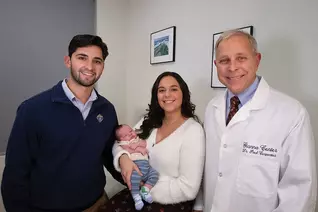 Franco and Katelyn Pellicciotta and their new baby visit with Dr. Paul Carpentier, director of the Gianna Center in Babylon, N.Y. (Photo by Jeffrey Bruno)
