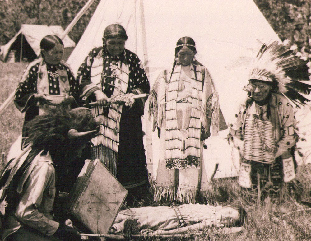 Nicholas Black Elk, kneeling in the foreground and wearing his buffalo horn headdress