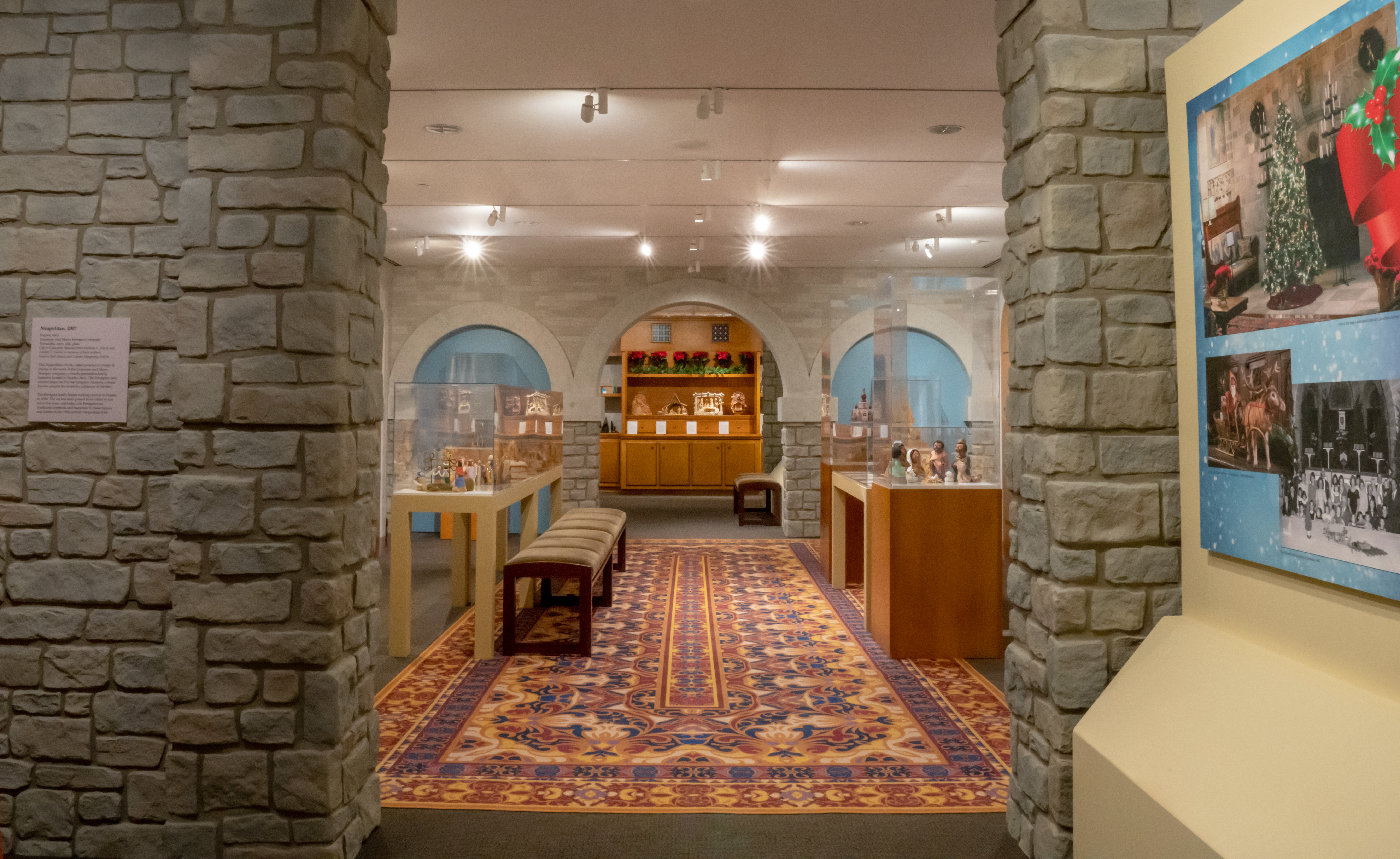 Photo of exhibit gallery featuring Nativity scenes in a faux stone castle setting inspired the architecture of Glencairn Museum.