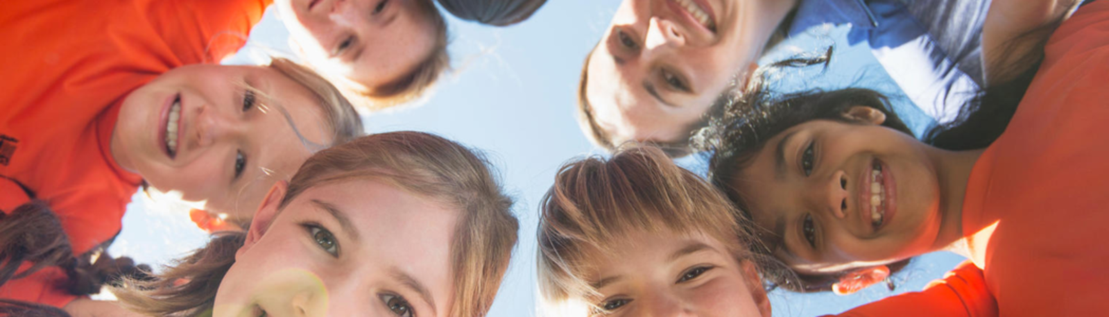 Image of children gathering together while playing sports.
