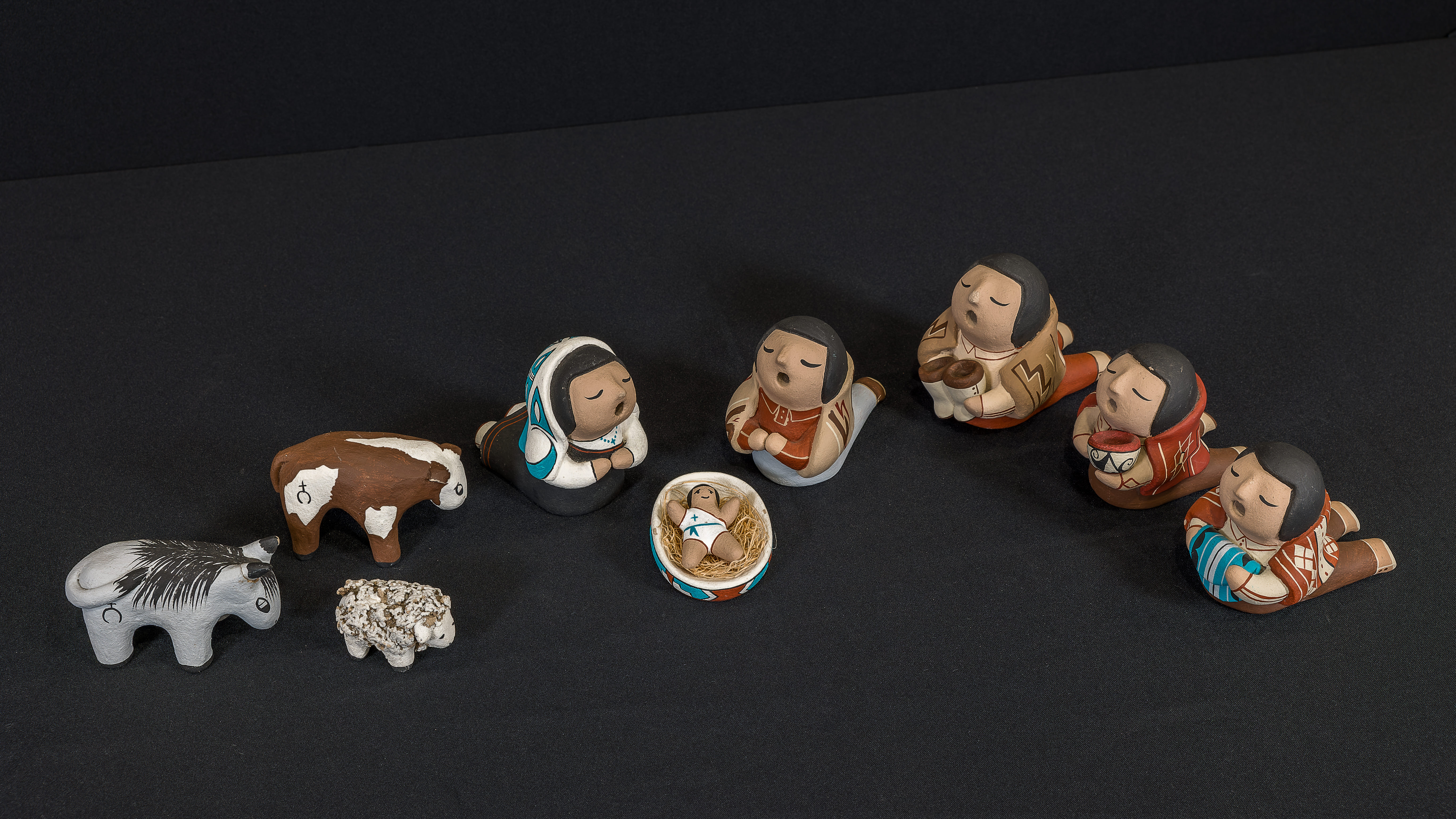 Crèche from the Cochiti Pueblo featuring Holy Family, three Magi, a donkey, a lamb, and an ox. 