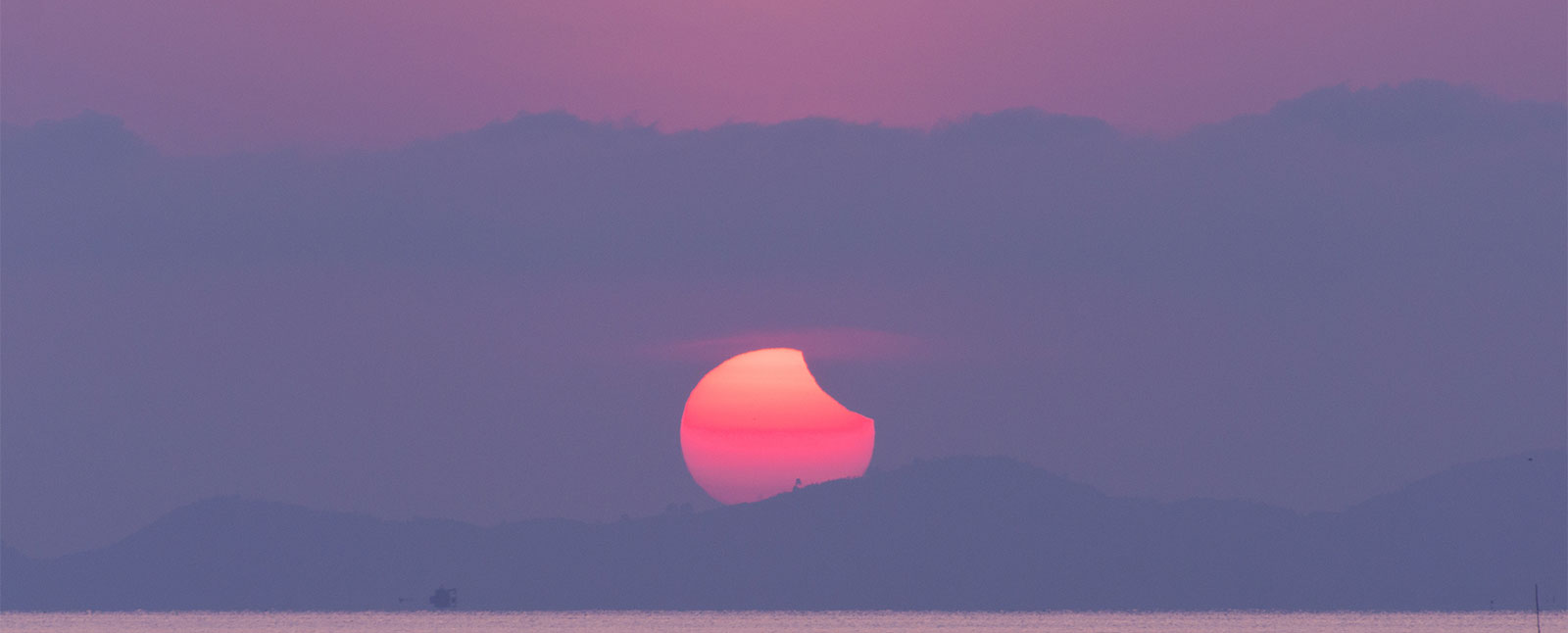 Solar Eclipse Sunrise over Mountains