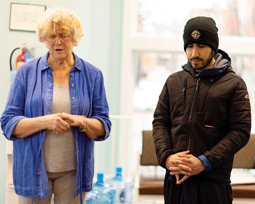 Janet Durig, director of the Capitol Hill Pregnancy Center, prays with then Deputy Grand Knight Justin Rinaldo (center) and then Grand Knight Logan Earnest during a council work day at the center last winter.