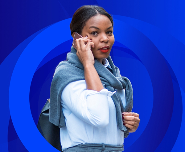 A woman is walking outdoors, talking on a pink mobile phone, with a grey sweater draped over her shoulders, set against a background of concentric blue circles.