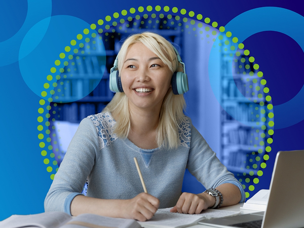 A young woman with blonde hair, wearing light-blue over-ear headphones, smiles as she takes notes at a desk in front of a laptop. She is visually accented by a bright green and blue circular graphic overlay.