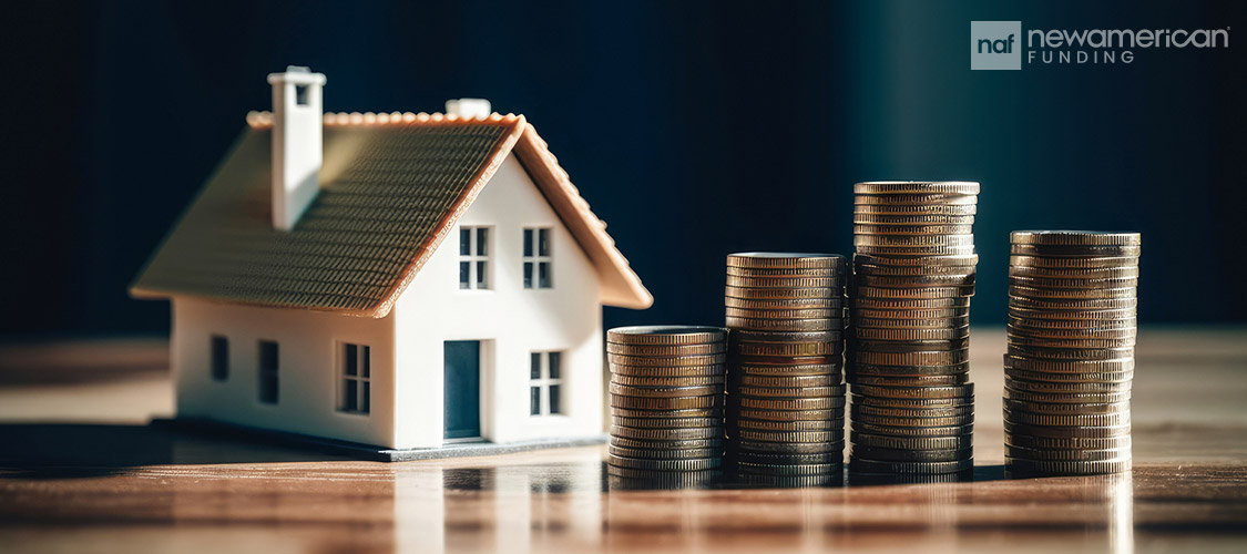 house model next to stacks of coins