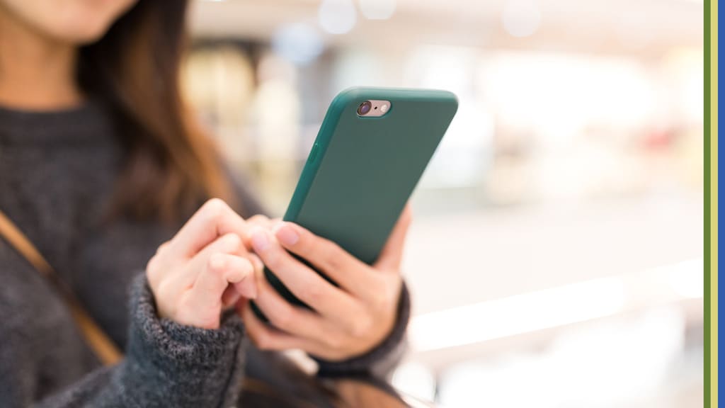 women holding smartphone