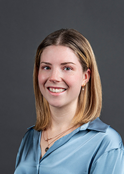 Headshot of Hannah Jensen, who smiles while wearing a light blue blouse