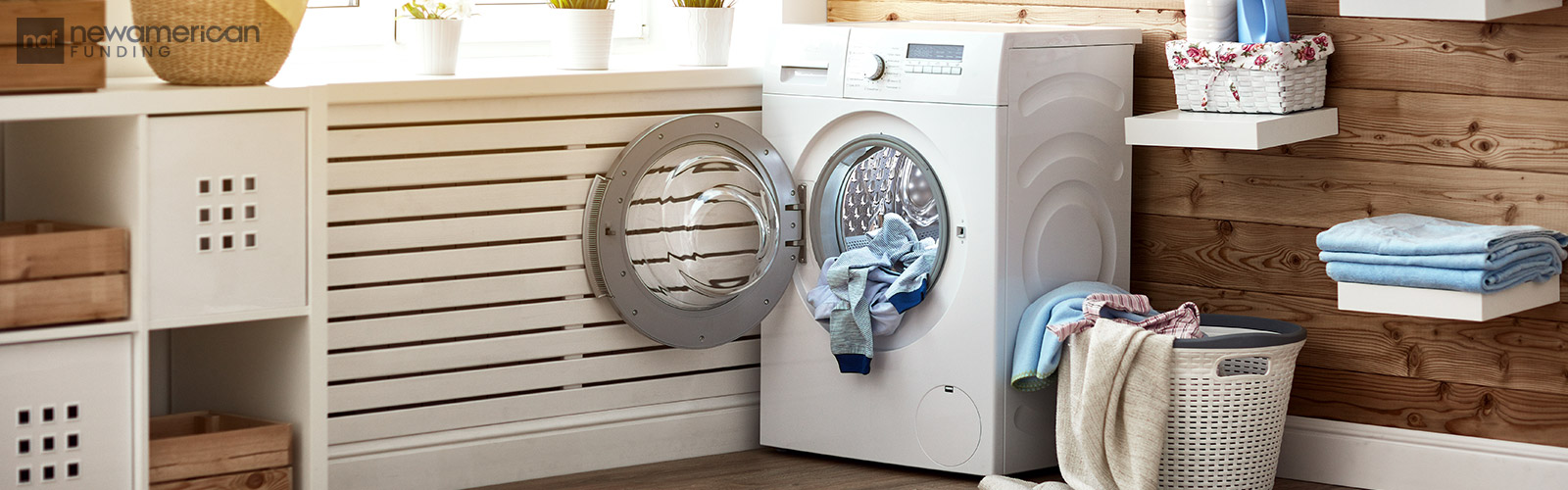 an open dryer sits in a tidy and well lit laundry room