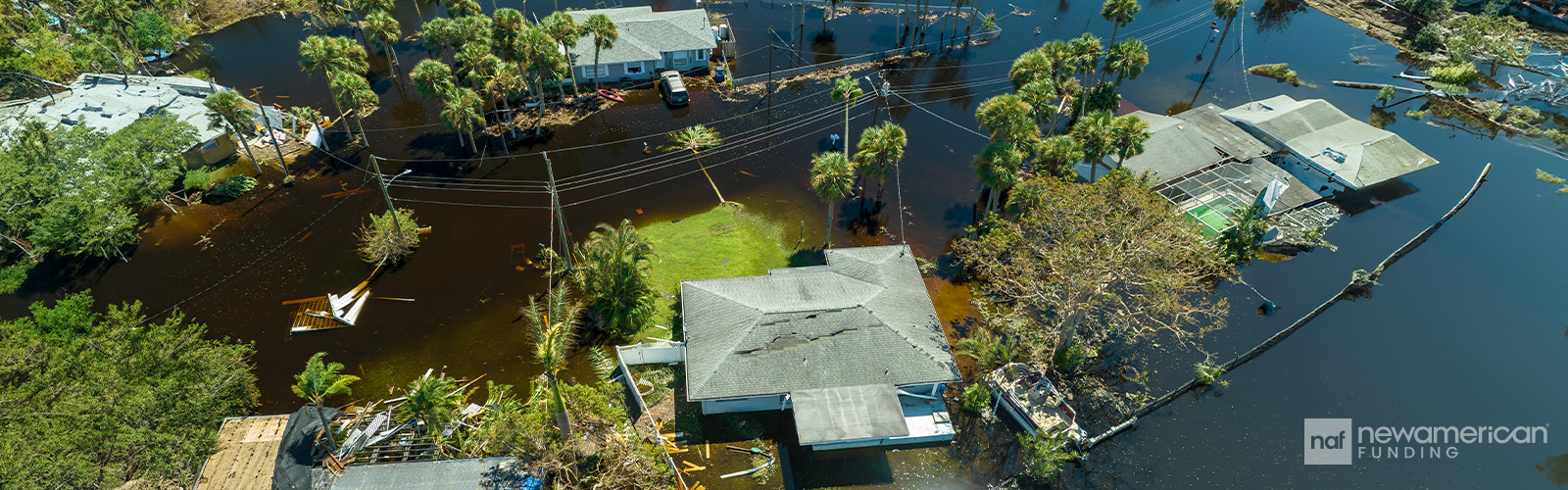 An overhead view of a flooded neighborhood where only the roofs are visible