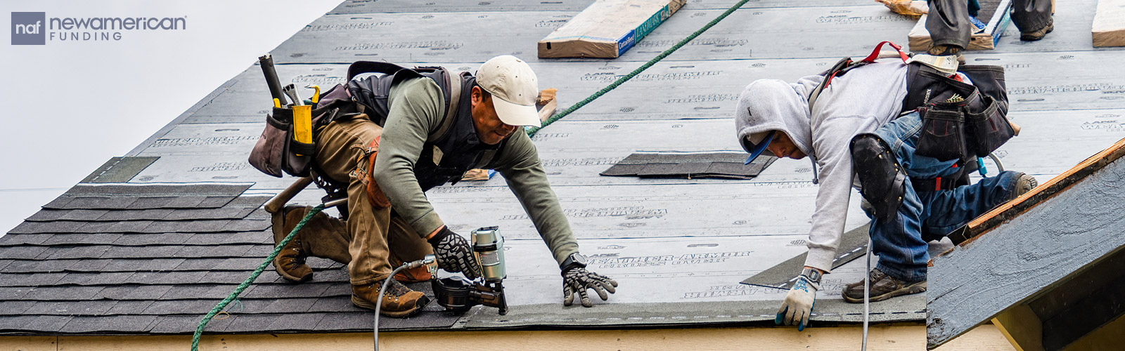 roofers laying down a new roof