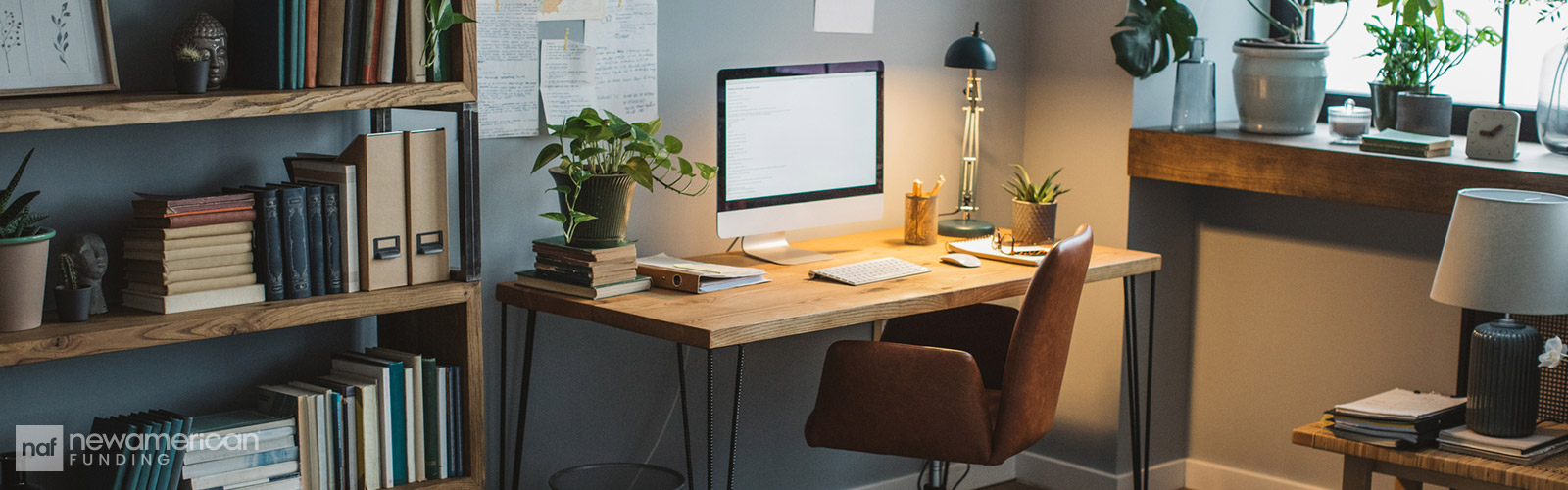 Aesthetic and well organized home office space with books, electronics, and plants
