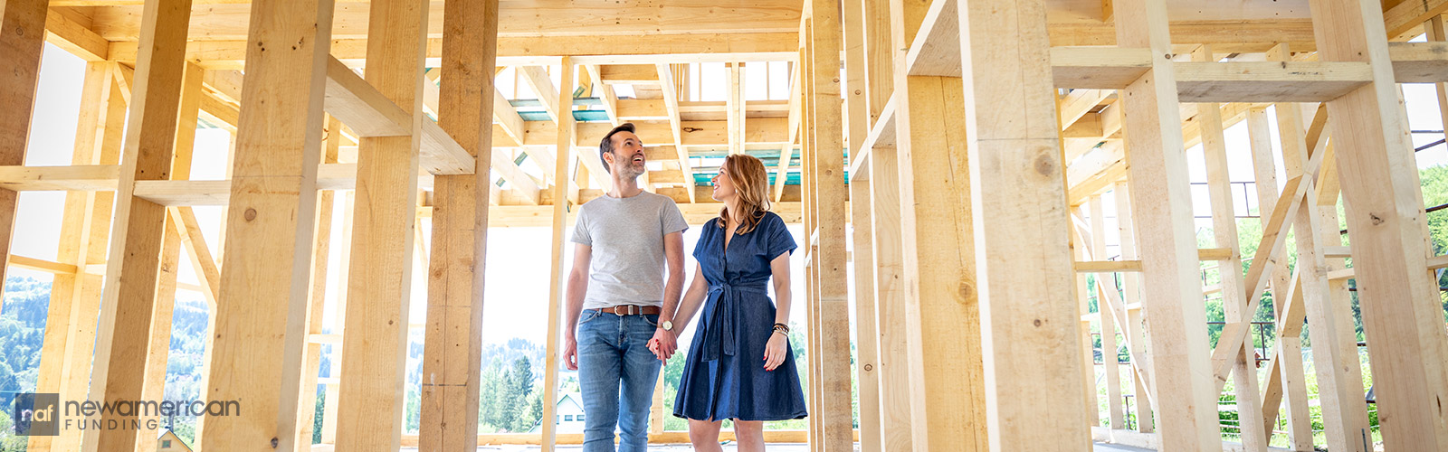 couple walking through their frame house