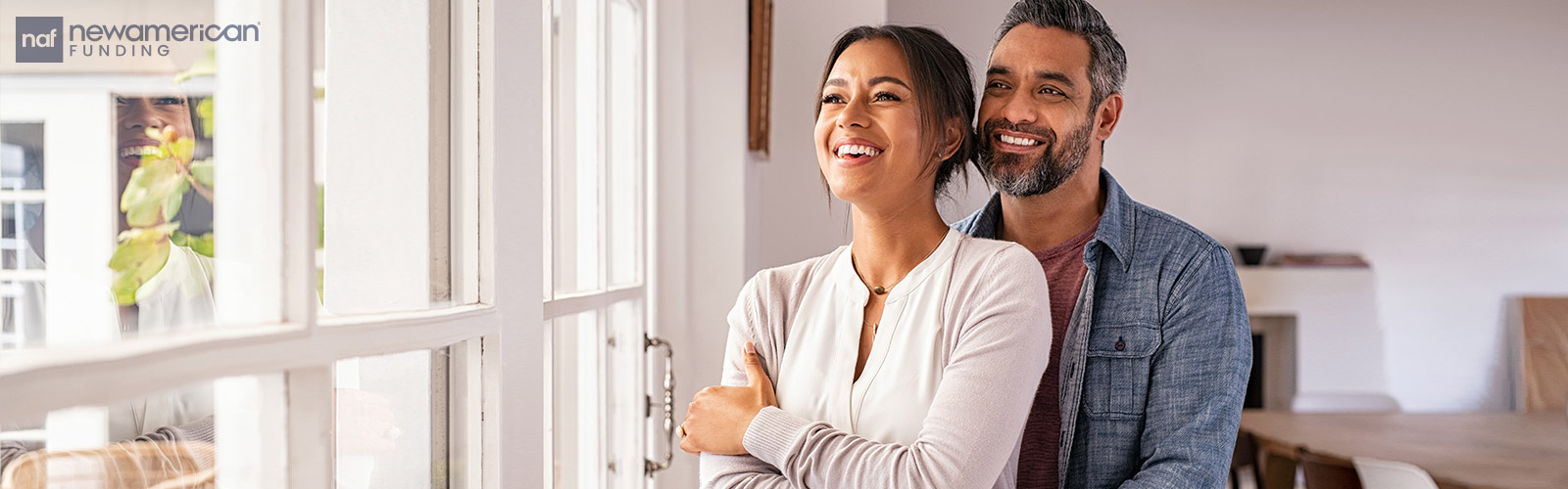 couple standing together by the window