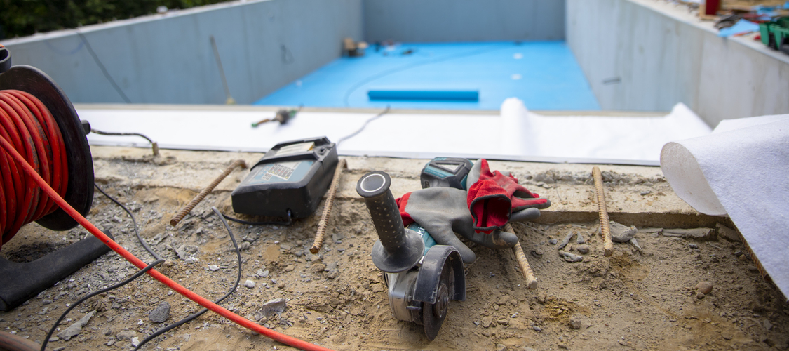 The shell of a backyard pool being installed/