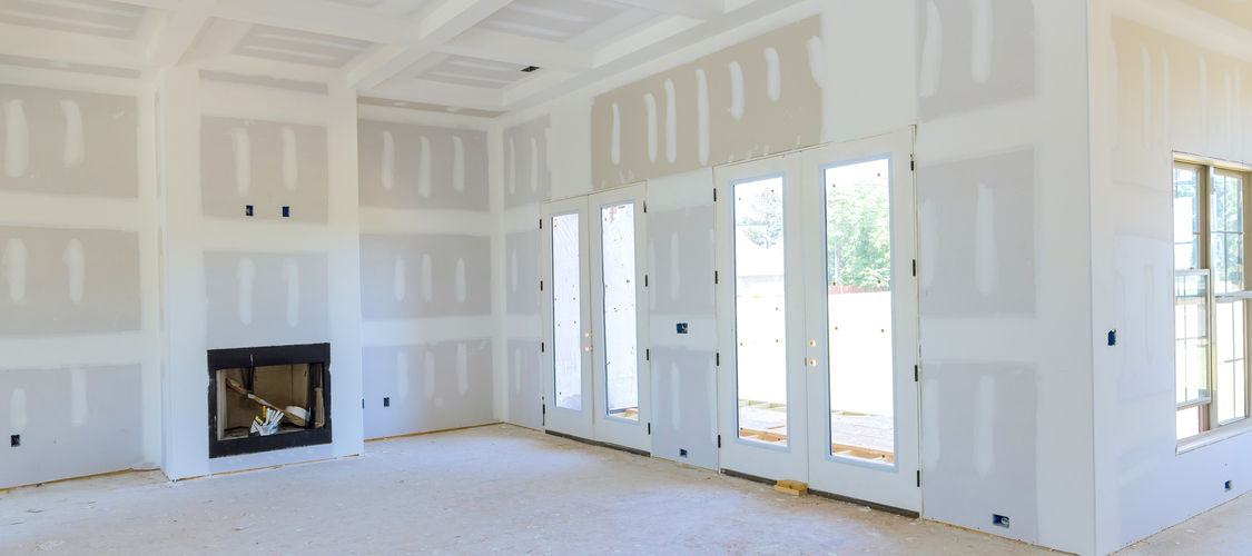 The inside of a room being drywalled.