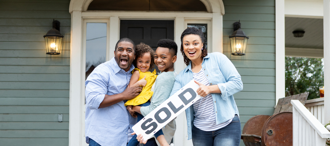 A man, young girl, pre-teen boy, and a woman holding up a