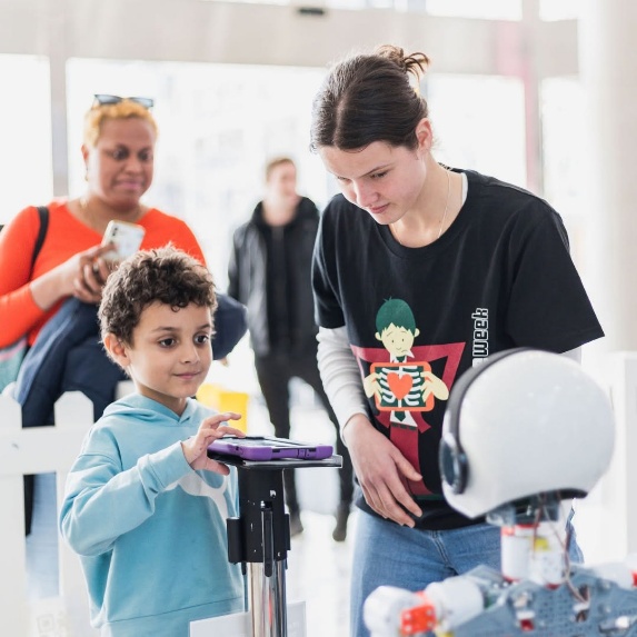 Boy and girl using tablet to control robot