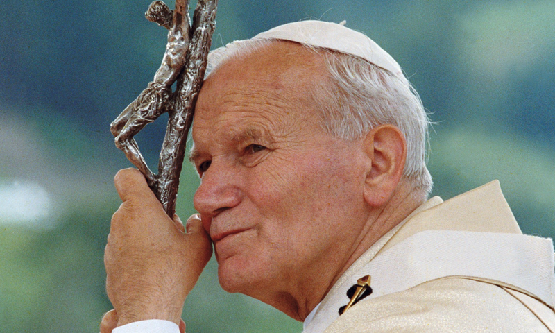 Picture of Pope John Paul II holding on to his staff with crucifix mounted on top.