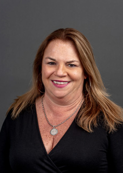 Headshot of Julia Parker, who smiles while wearing a black blouse 