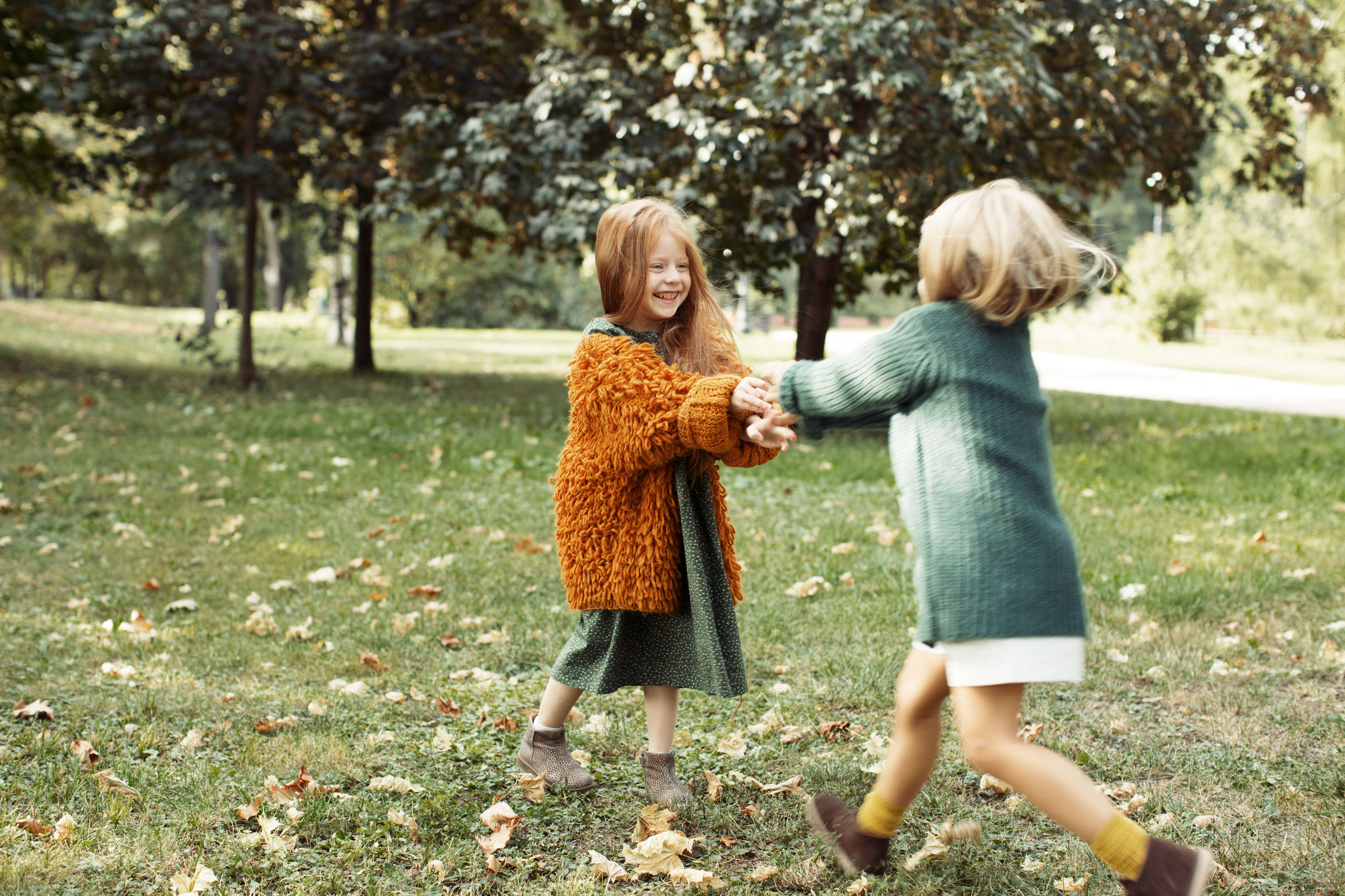 two kids play in a garden
