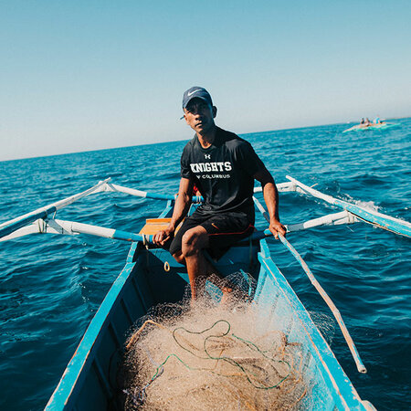 Jeffrey Rentegrado, a member of Davila Council 14302 in Pasuquin, Luzon, navigates fishing grounds off the northwest coast of the Philippines.