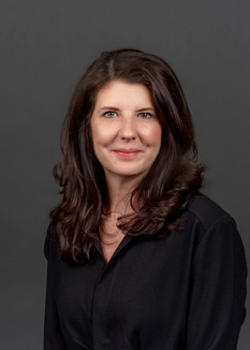 Headshot of Kristin Manning, who smiles while wearing a black blouse