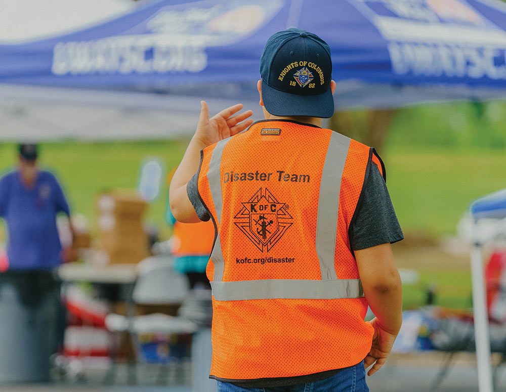 A K of C volunteer directs traffic during a meal distribution organized by Knights at St. Charles Borromeo Church in Destrehan. The team cooked nearly 800 meals for people who had lost power.