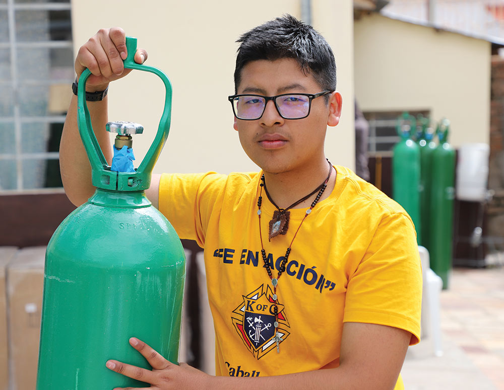 A young man in Huancan&eacute;, Peru, helps to unload oxygen tanks donated by the Supreme Council