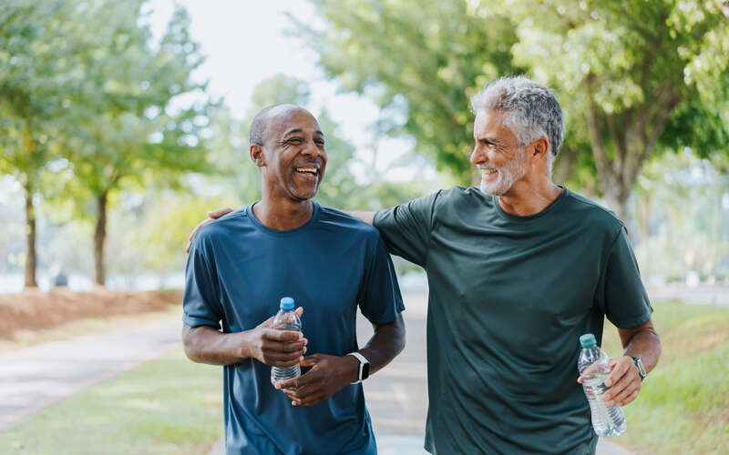 two men walking on exercise trail