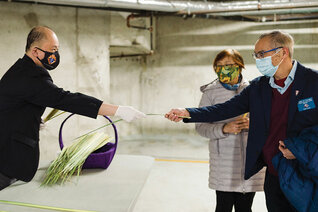 Webster Licaros, Marcus Wong and Vance Licaros (left to right) of St. Francis Xavier Council 10500 dish up meals April 10 to deliver to The Door is Open, an archdiocesan ministry that supports people experiencing homelessness.
