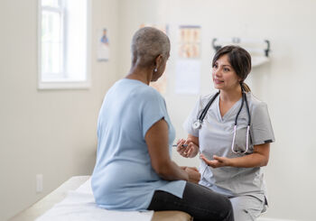 woman in an exam room during patient appointment with her doctor
