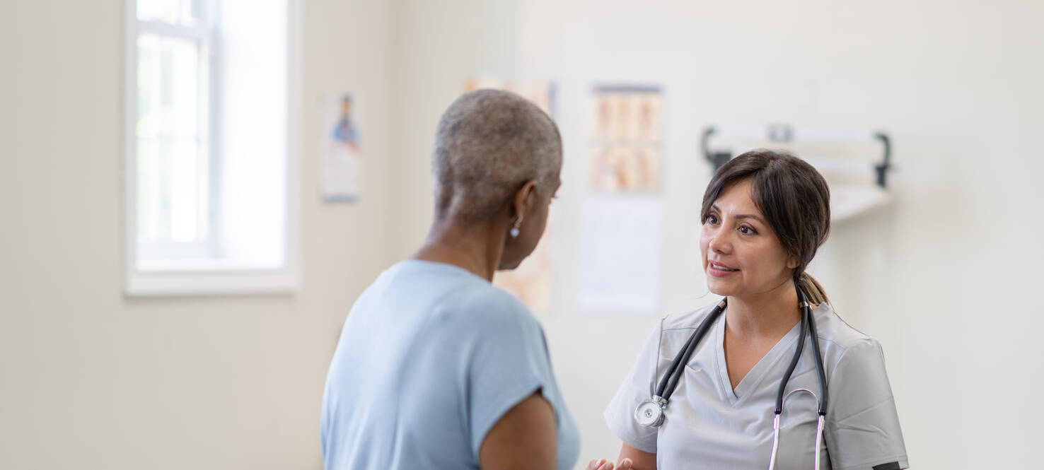 woman in an exam room during patient appointment with her doctor