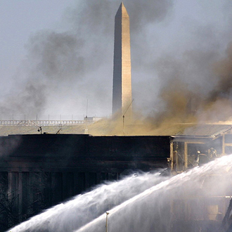 Fire crews in Arlington, Va., spray water on the Pentagon after an airliner crashed into the building in Sept. 11, 2001.