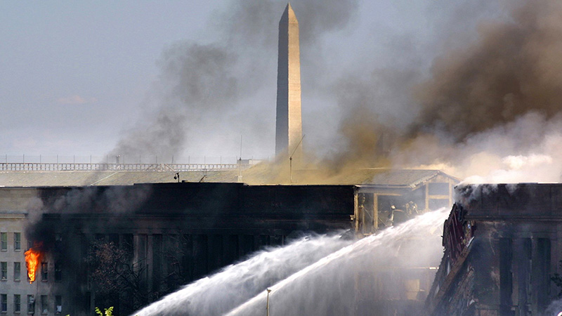 Fire crews in Arlington, Va., spray water on the Pentagon after an airliner crashed into the building in Sept. 11, 2001.