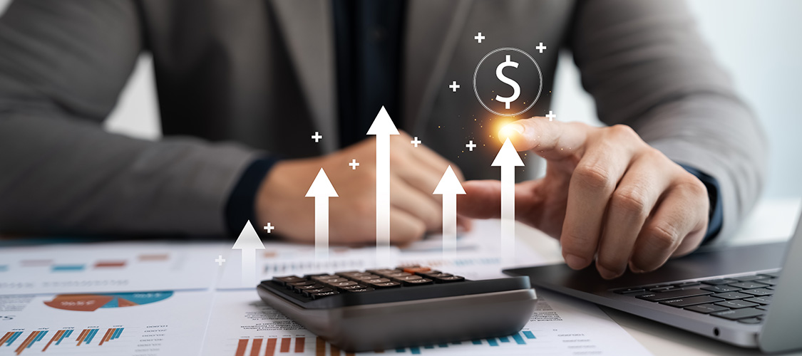 Someone on a calculator looking at projections with arrows shooting up.